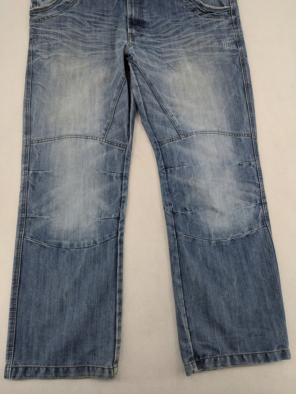 Premium Denim blue straight leg jeans with biker knee inserts and five-pocket design.