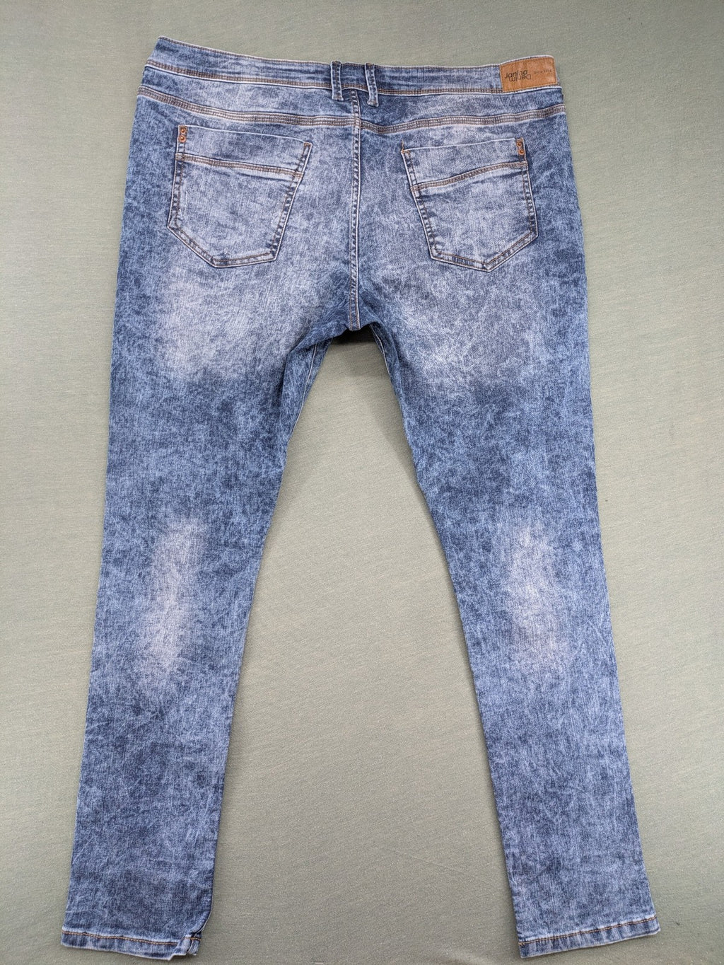 Janina blue slim fit jeans with acid wash, destroyed details, and button fly.