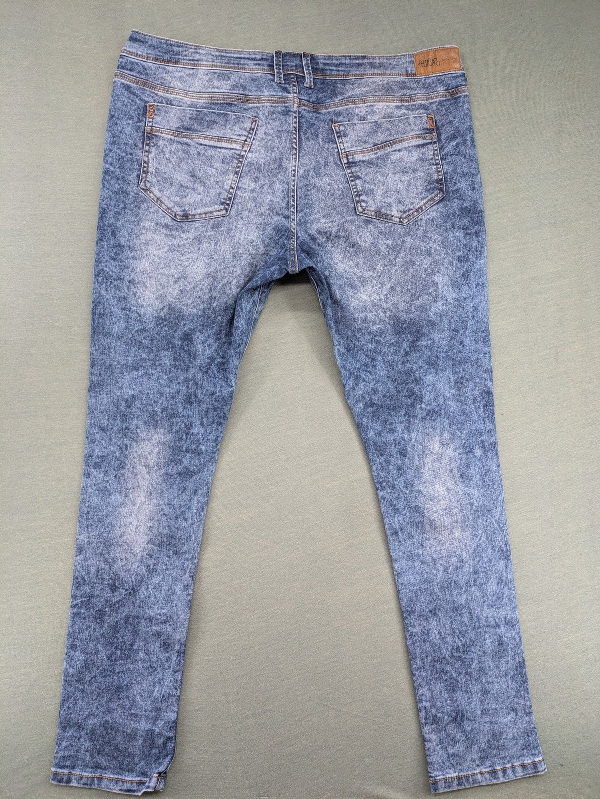 Janina blue slim fit jeans with acid wash, destroyed details, and button fly.