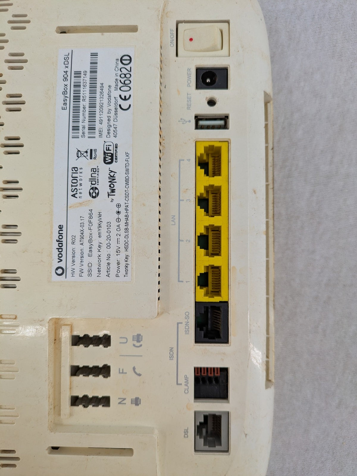 Vodafone wireless router beige and black with multiple LAN ports and USB connection.