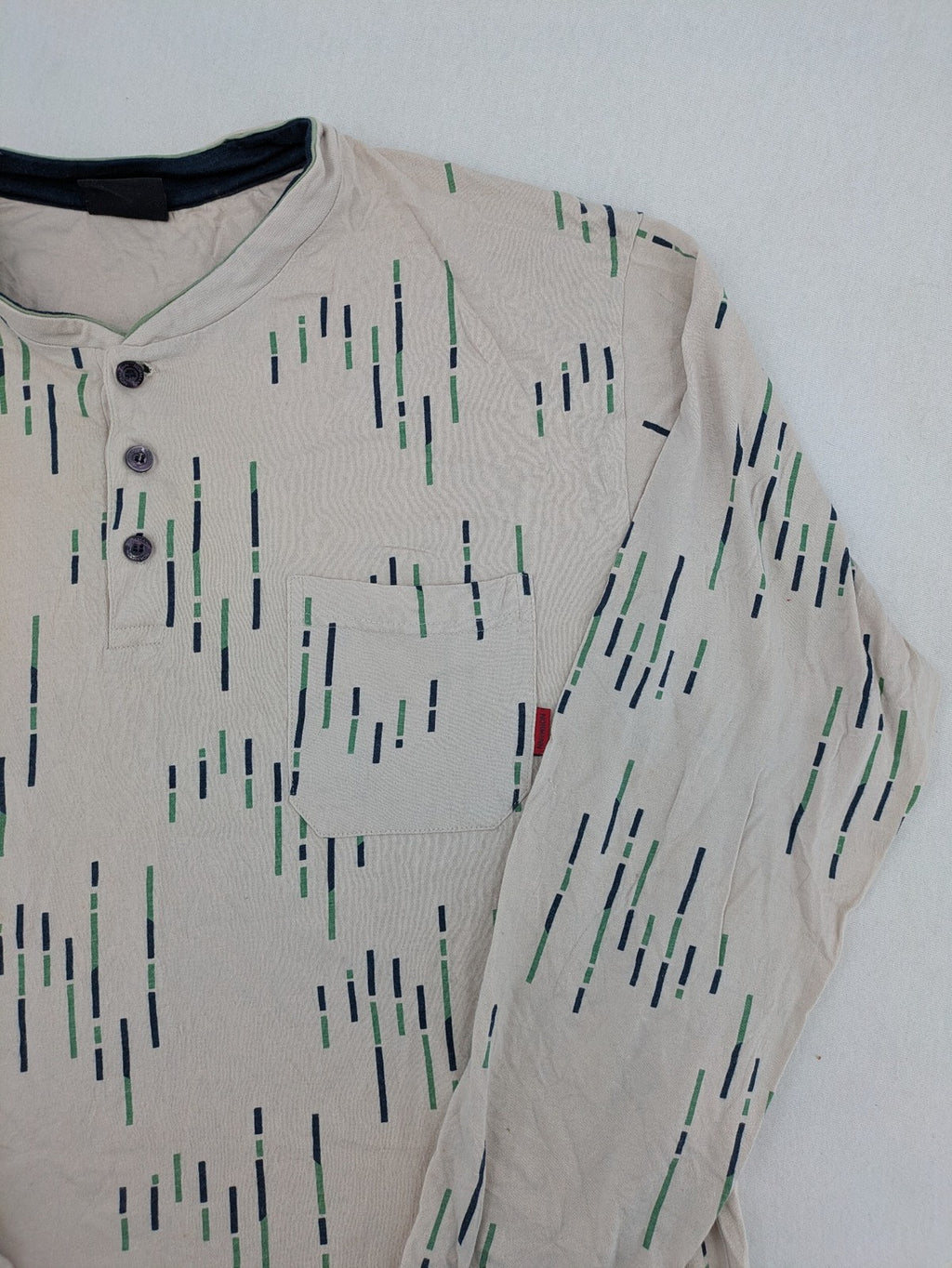 Normann beige striped long sleeve Henley shirt with button placket and chest pocket.