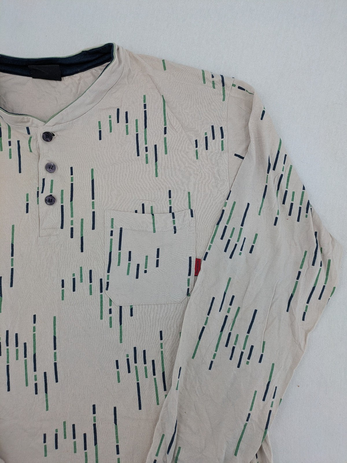 Normann beige striped long sleeve Henley shirt with button placket and chest pocket.