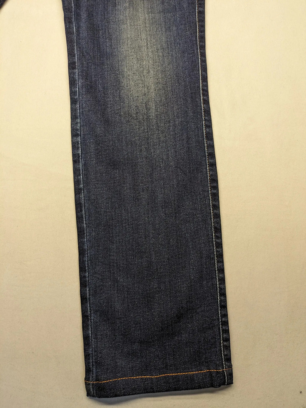Diesel blue straight jeans with regular waist, dark wash, and stretch material.