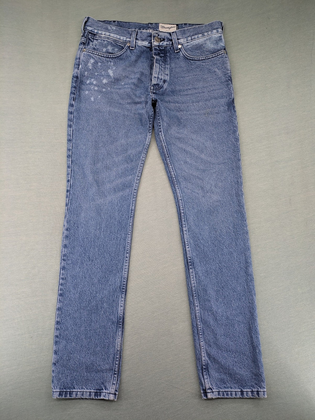Wrangler blue straight jeans with button fly and classic 5-pocket design.