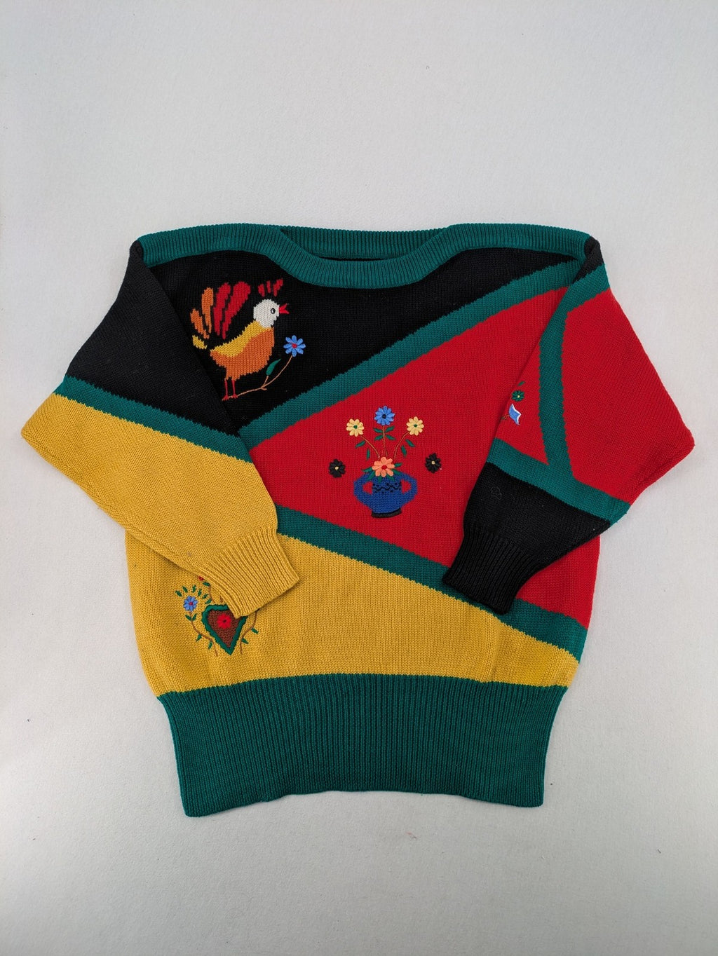 Pullover multi knit jumper featuring colorful block pattern and embroidered rooster and flowers.