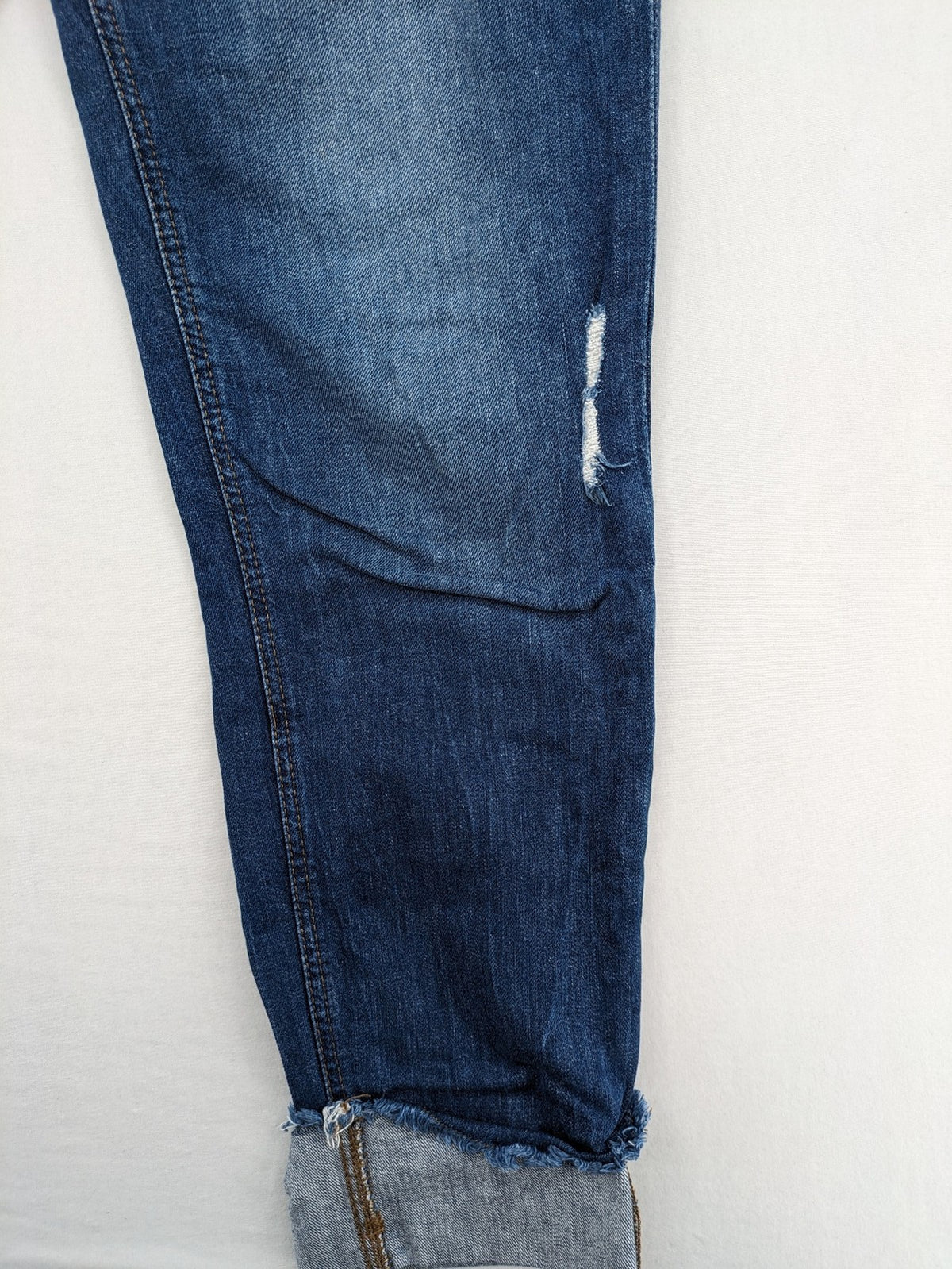 Esprit blue straight leg jeans with ripped knee details and rolled hem.