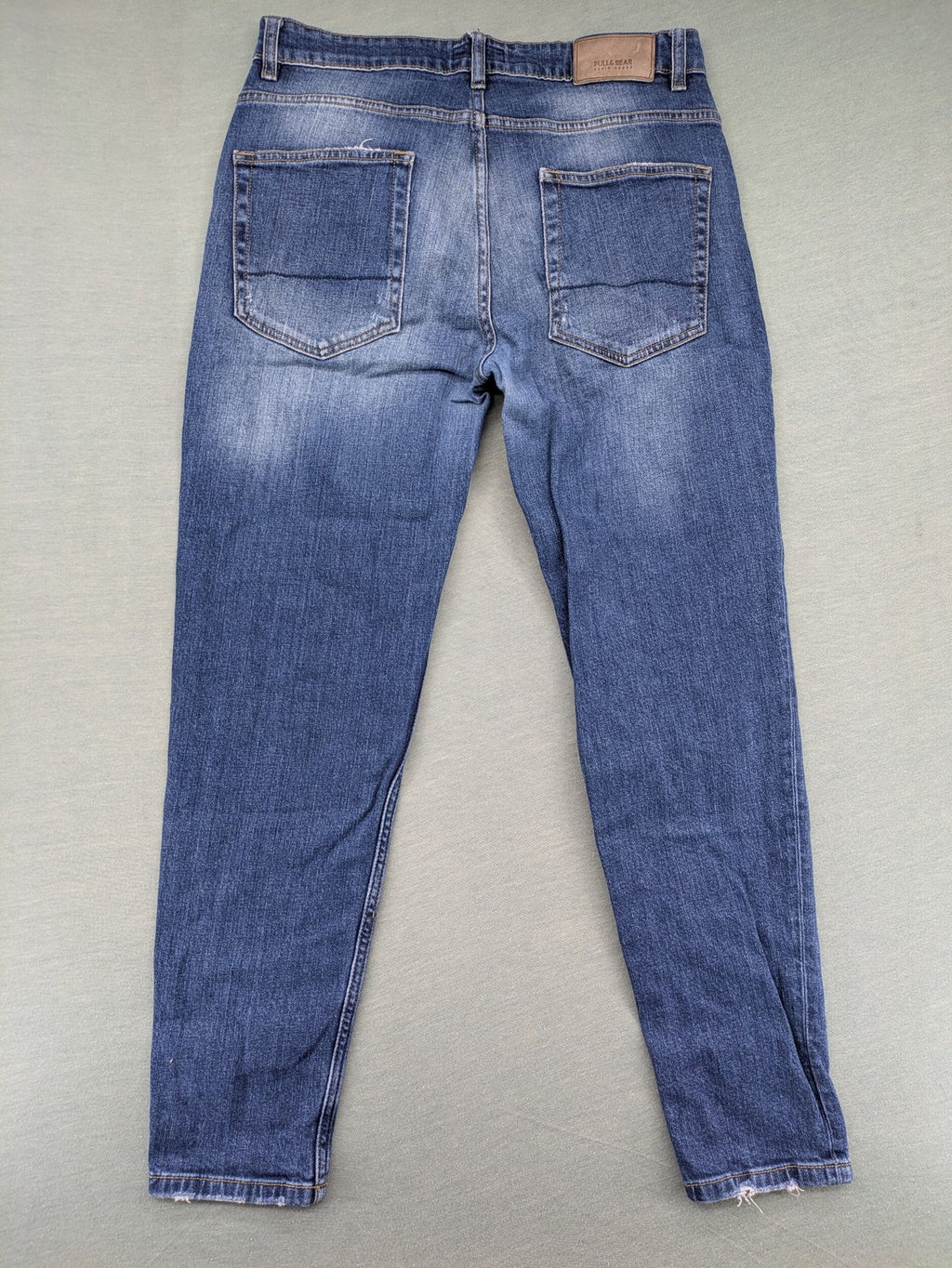 Pull & Bear blue distressed ripped straight jeans with button fly and classic wash.