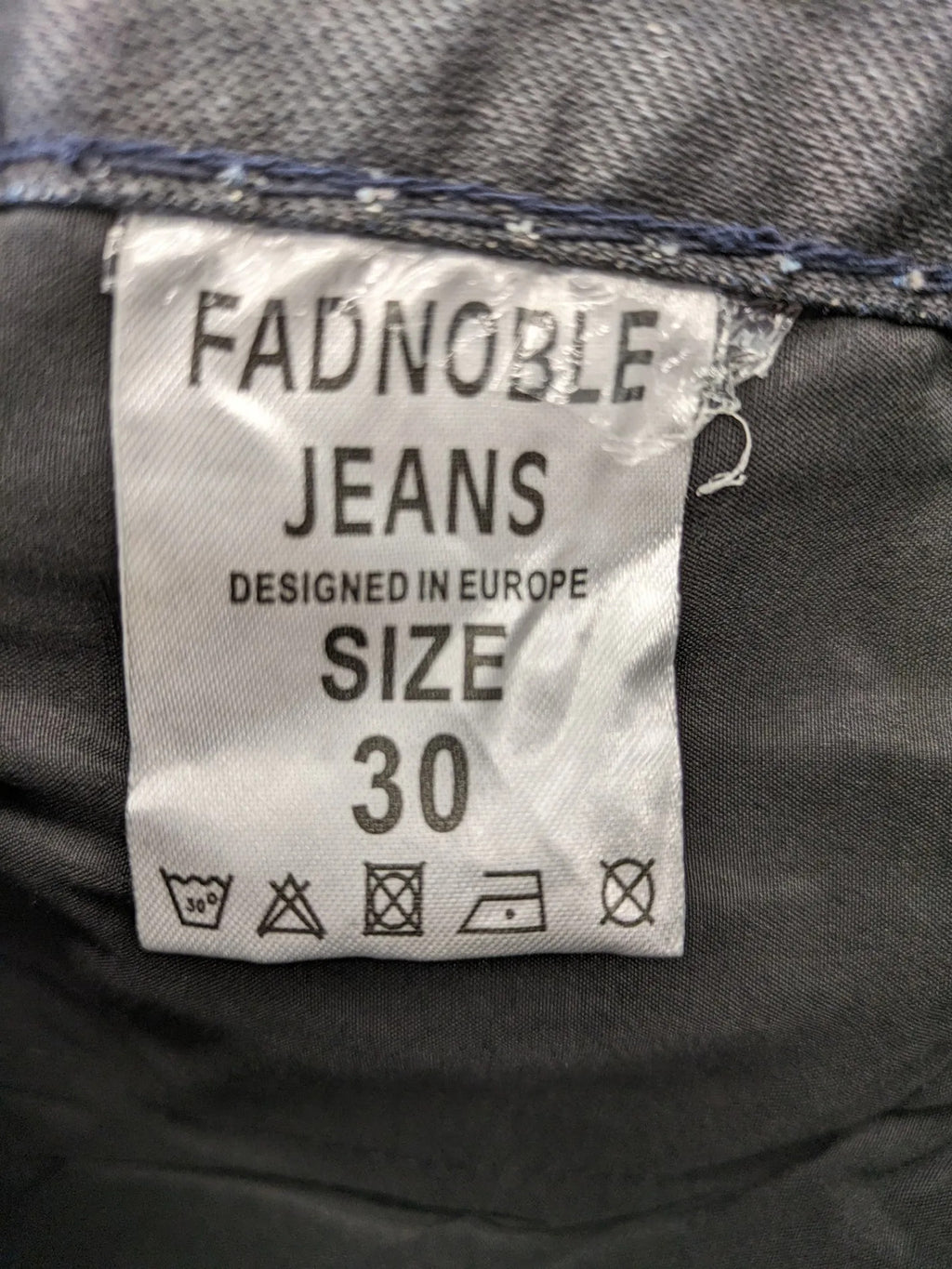 Fadnoble grey straight jeans with button fly and contrasting stitching details.