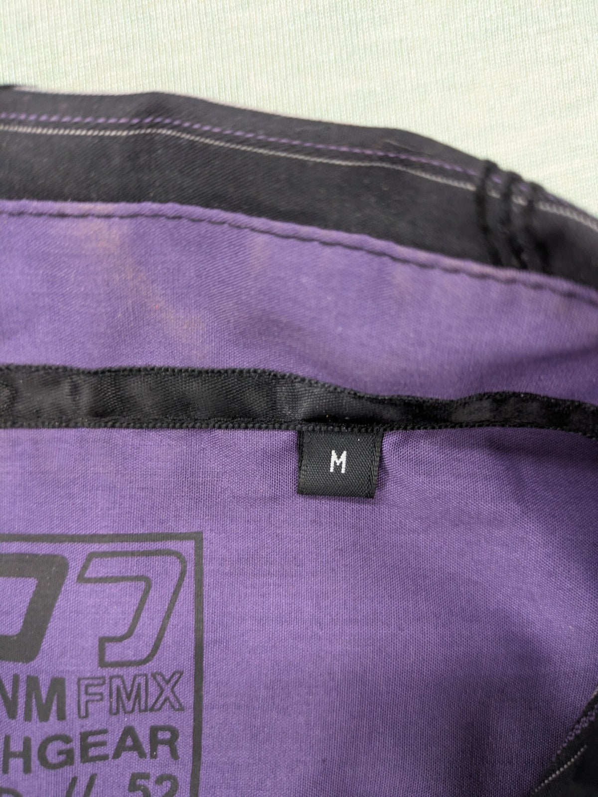 Clockhouse short-sleeve shirt grey purple striped with abstract black graphic pattern and purple collar.