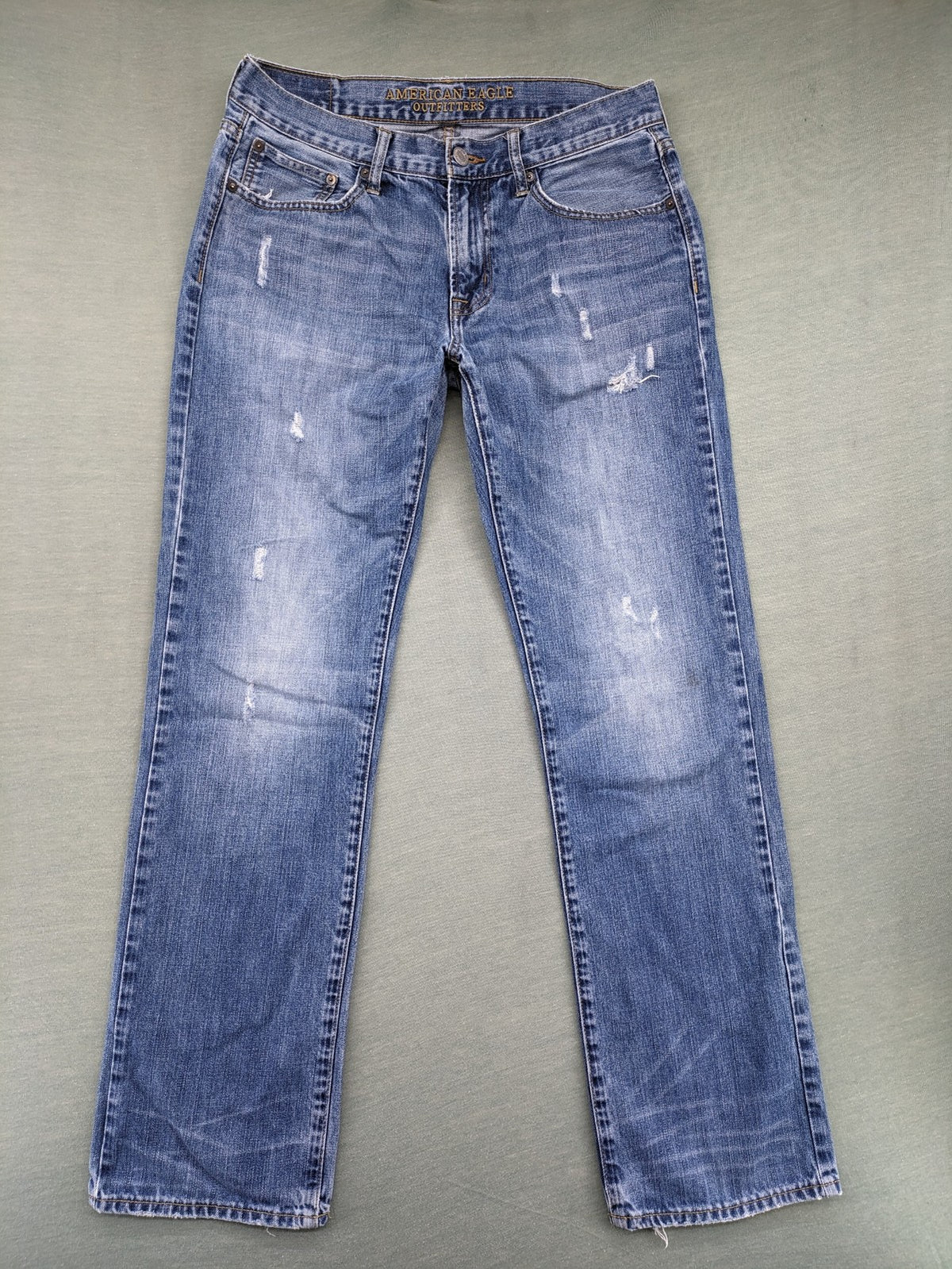 American Eagle Outfitters blue straight jeans with distressed detailing and classic five-pocket design.