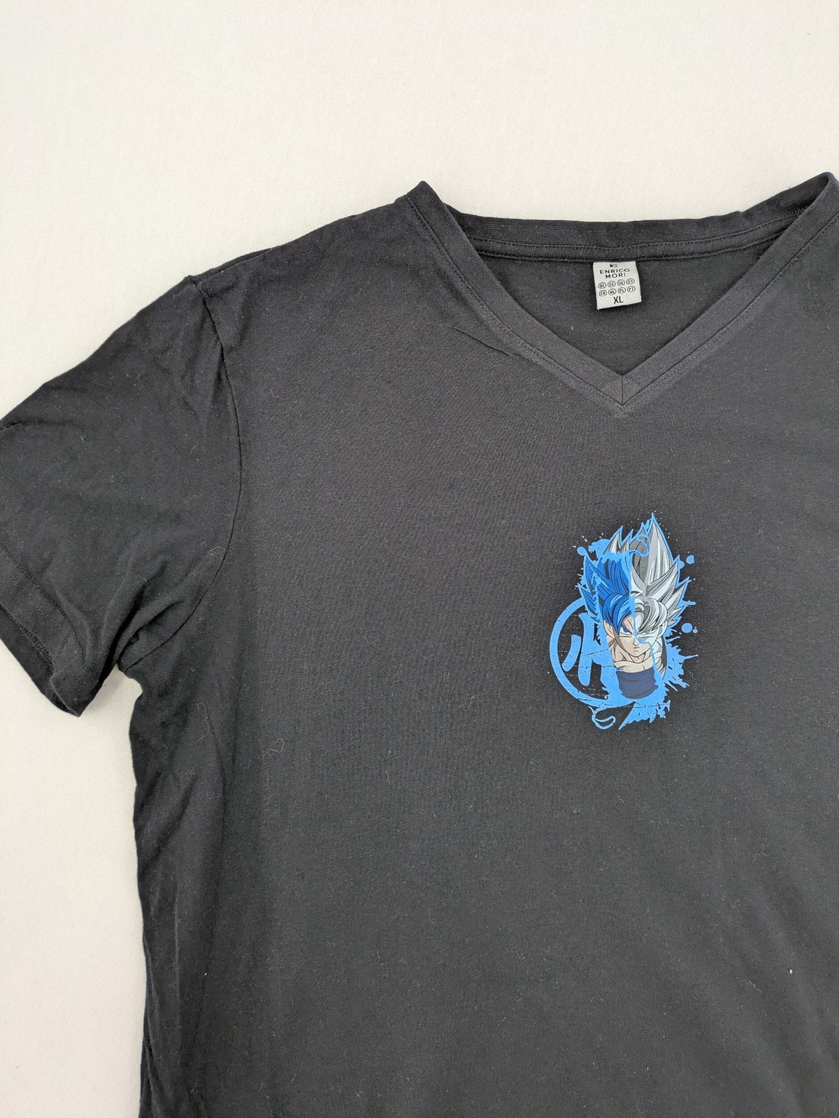 Dragon Ball Super blue t-shirt featuring Goku graphic in Super Saiyan and Ultra Instinct forms.