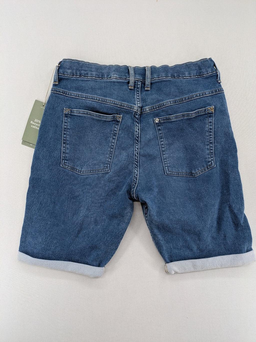 H&M blue denim shorts with adjustable drawstring, rolled hem, classic 5-pocket design.