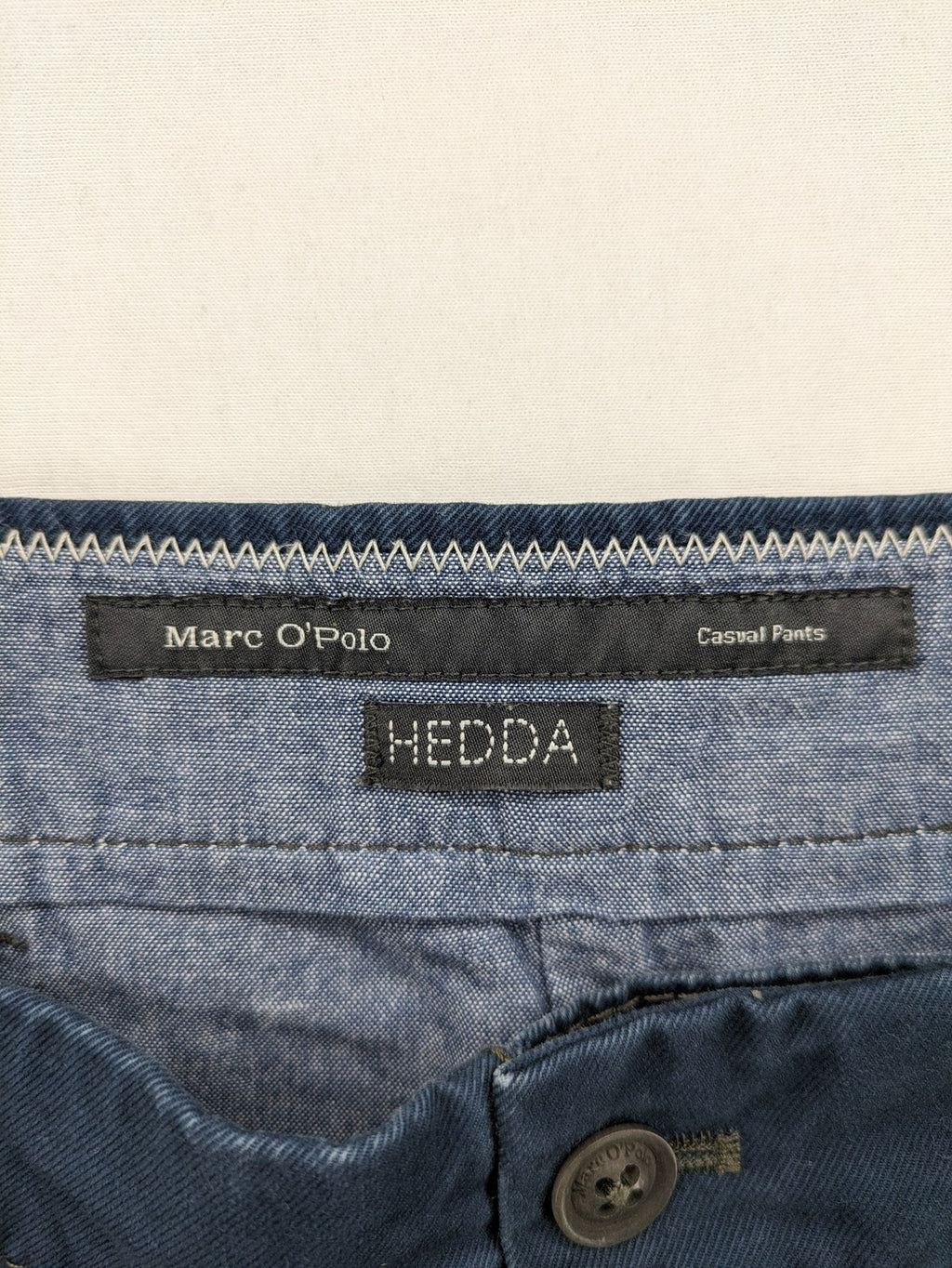 Marc O'Polo blue chino pants with button flap pockets and relaxed fit design.