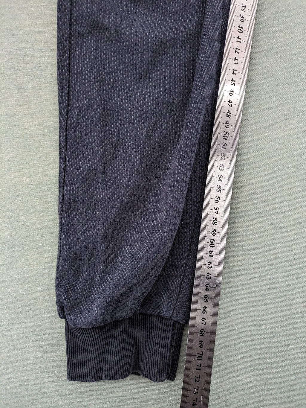 Nike F.C. grey jogger pants with elastic waistband, side pockets, and embroidered Swoosh logo.