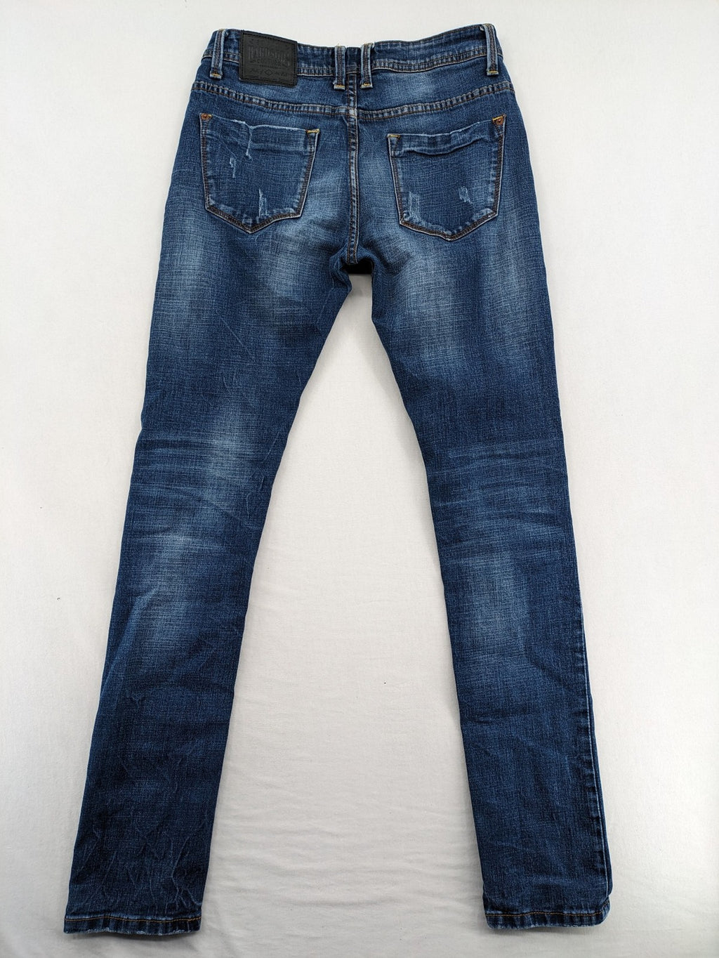 Soda blue straight jeans with distressed rips and button fly, cotton blend material.