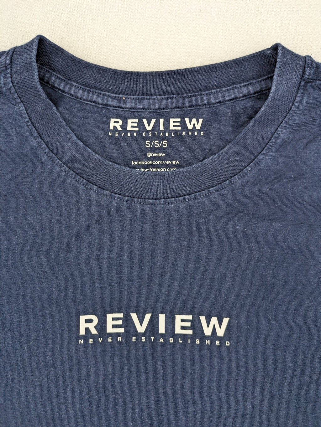 Review navy band t-shirt with "Never Established" logo print, 100% cotton.