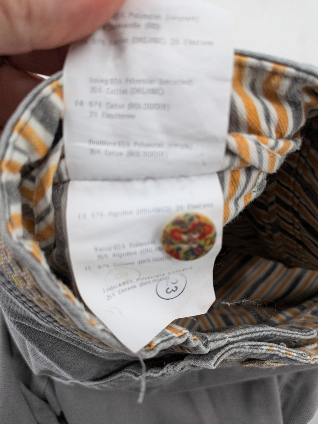 MMX grey chino pants with patterned interior lining and contrasting waistband, made from organic cotton.