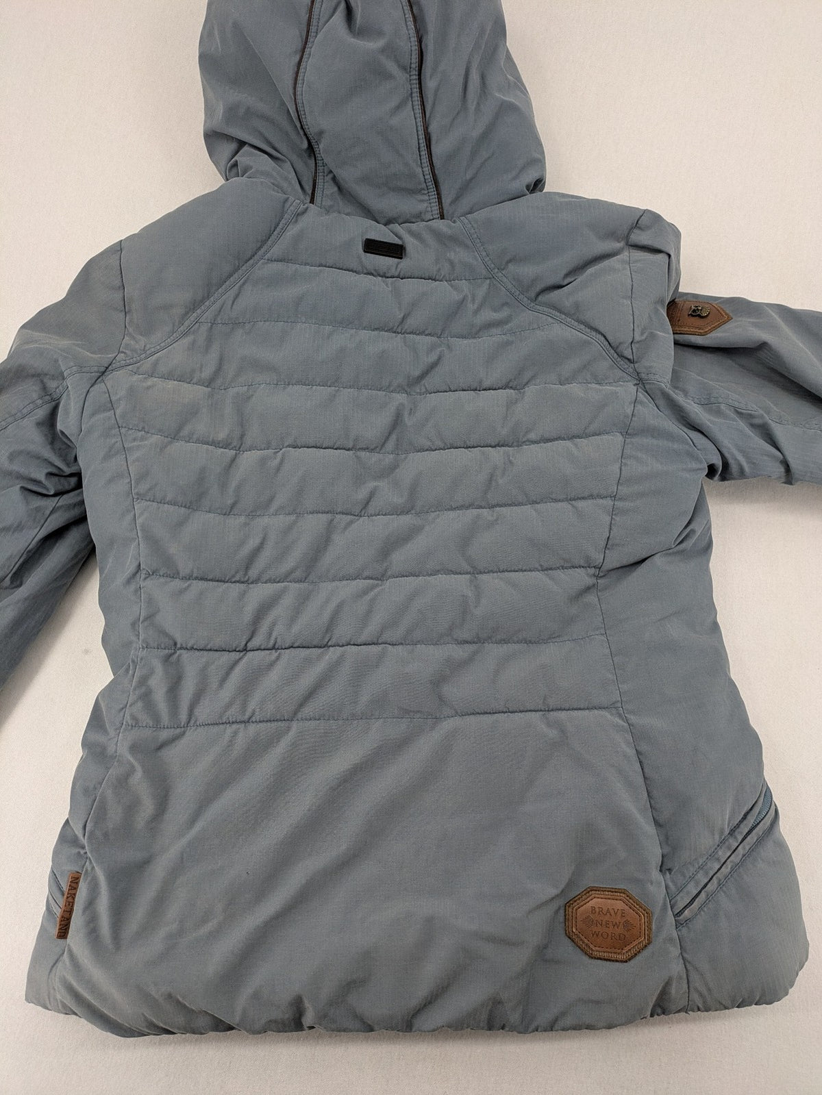 Naketano blue jacket with teddy fleece lining, hood, and leather appliqués.