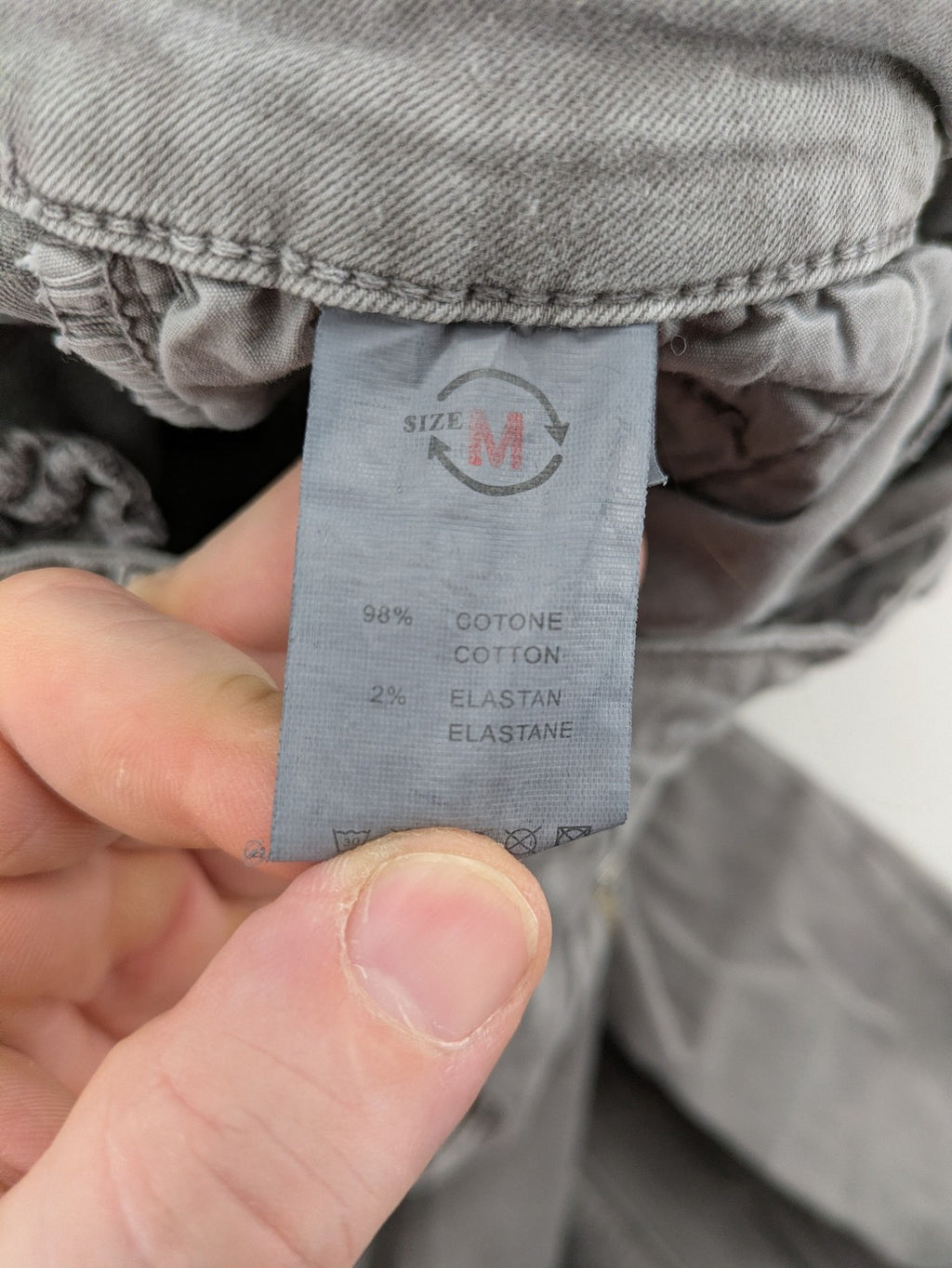 Made in Italy grey biker jeans with zip pockets and structured knee detailing.