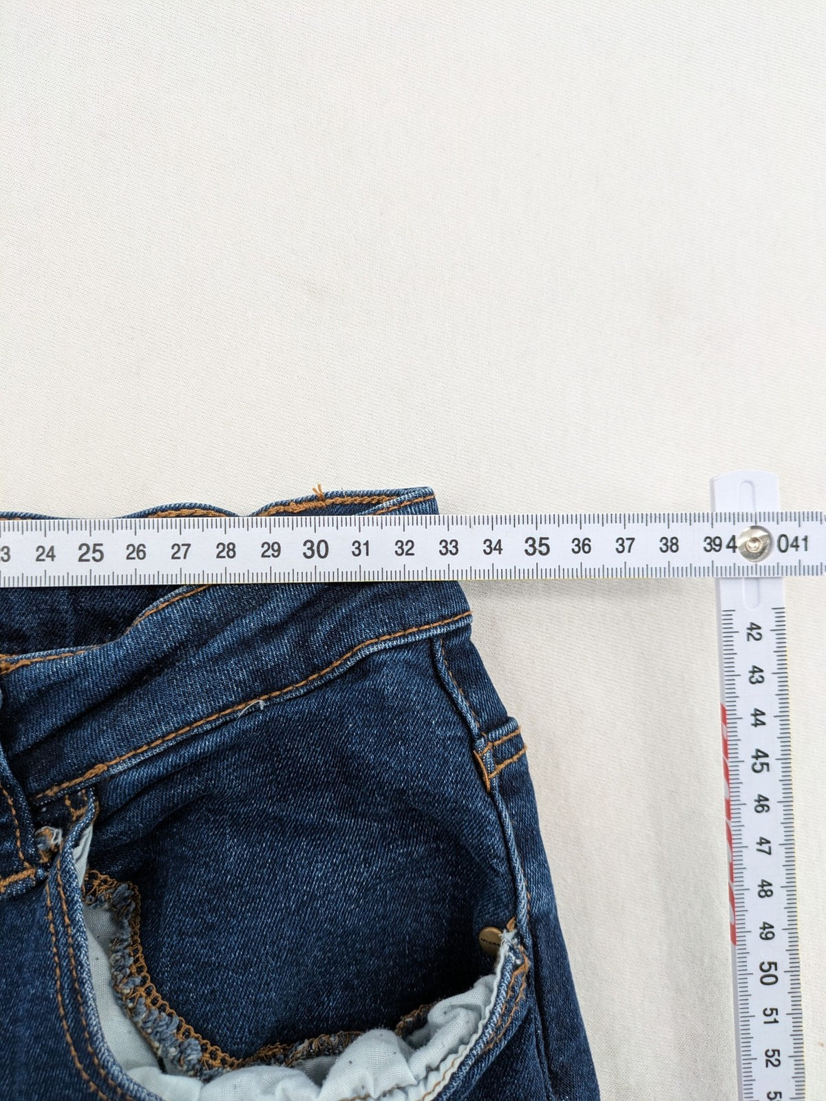 Denim & Co. blue skinny stretch jeans, five-pocket design, dark wash, durable material.