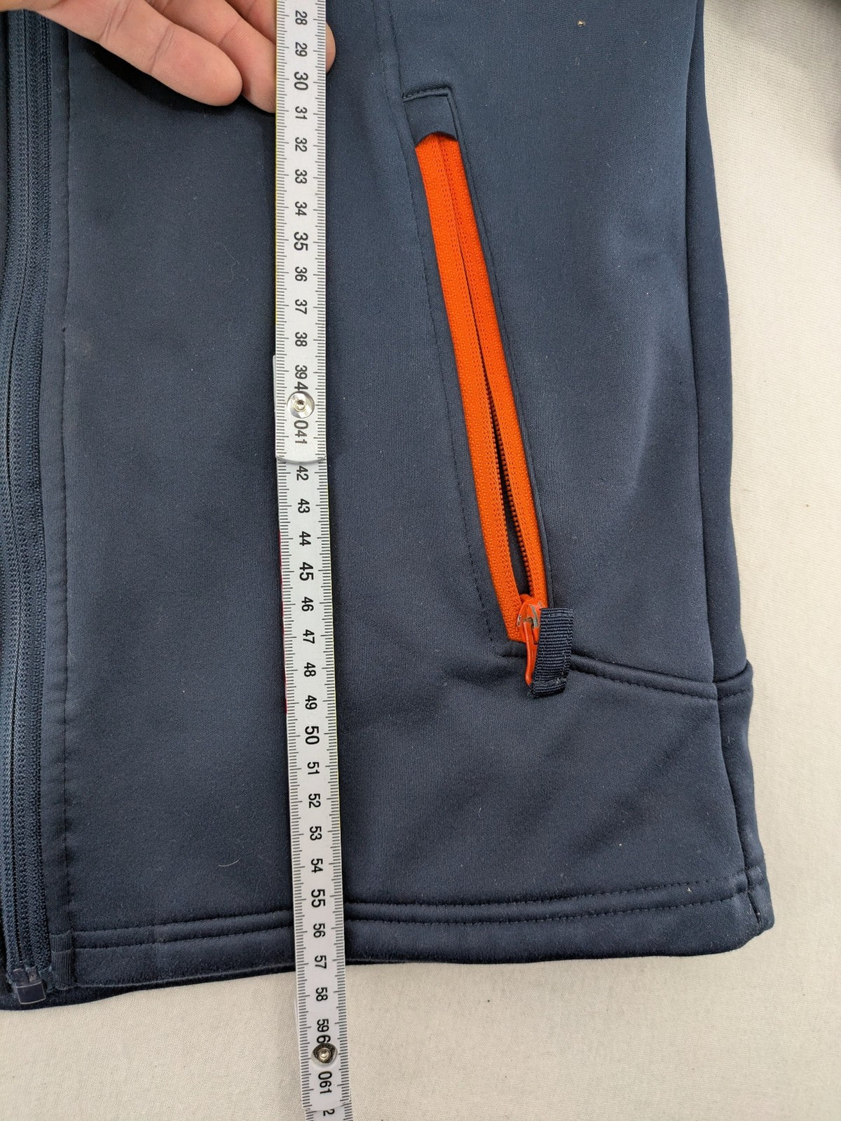 Crane navy softshell jacket with fleece lining, full zip, orange accent zippers.
