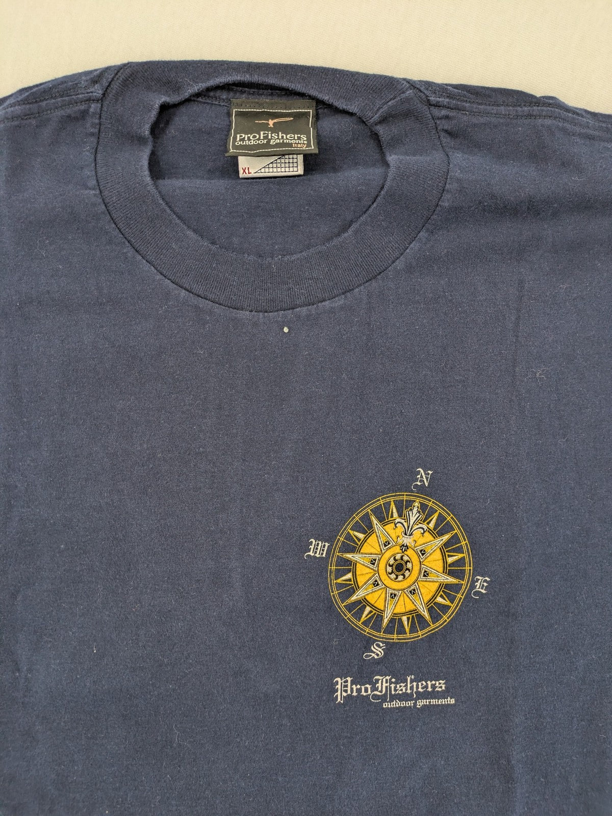 ProFishers navy t-shirt with compass print and large fish graphic on back.