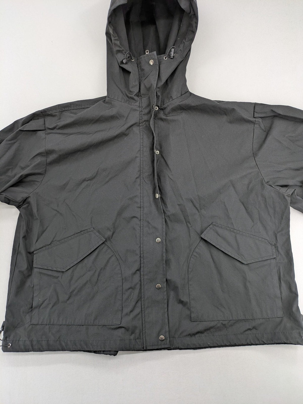 Hypnotism grey windbreaker jacket with hood, snap buttons, and zip closure.