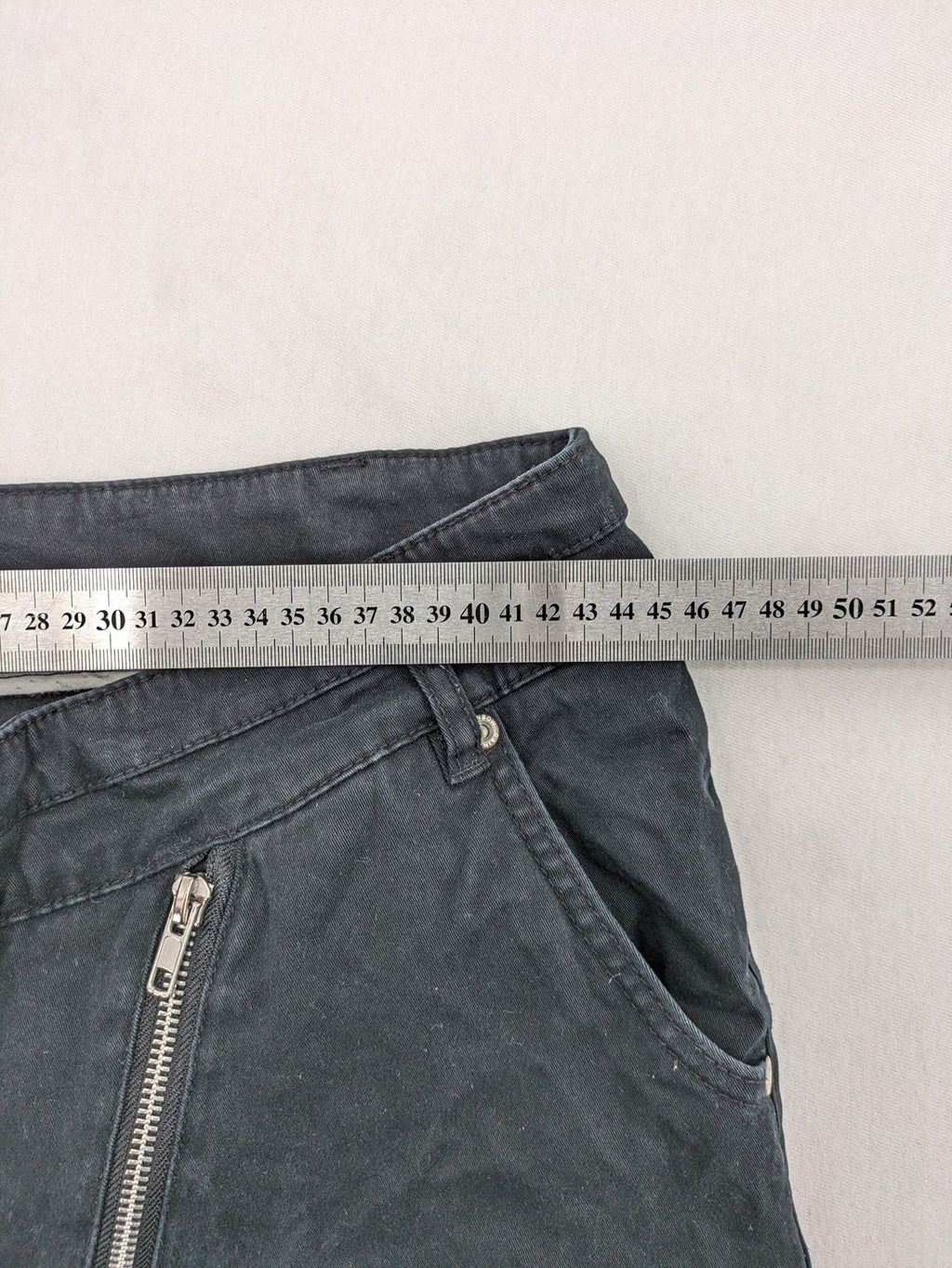 REI grey pants asymmetrical design with diagonal zipper and button placket, cotton blend.