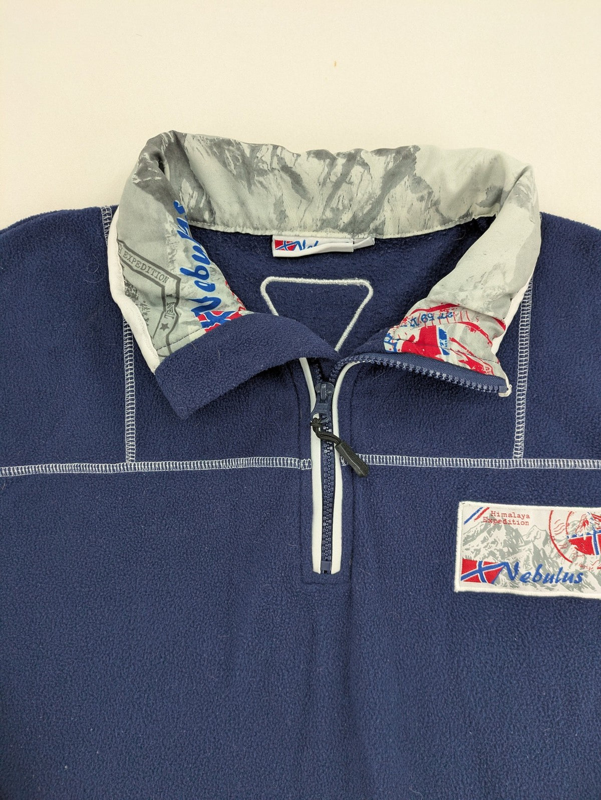 Nebulus navy turtle neck jumper with graphic print collar and "Himalaya Expedition" patch.