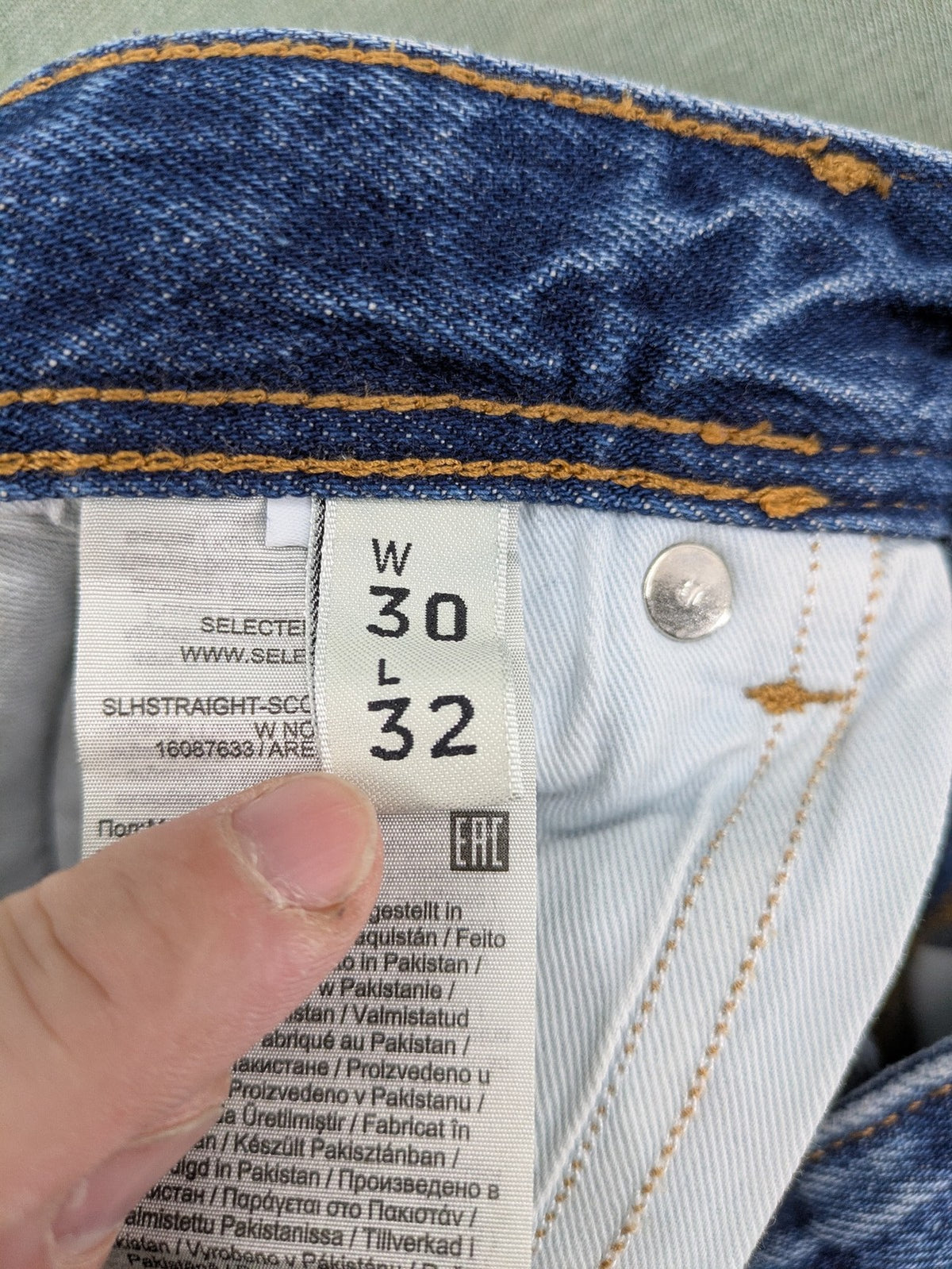 Selected Homme blue straight fit jeans with classic five-pocket design and medium wash denim.