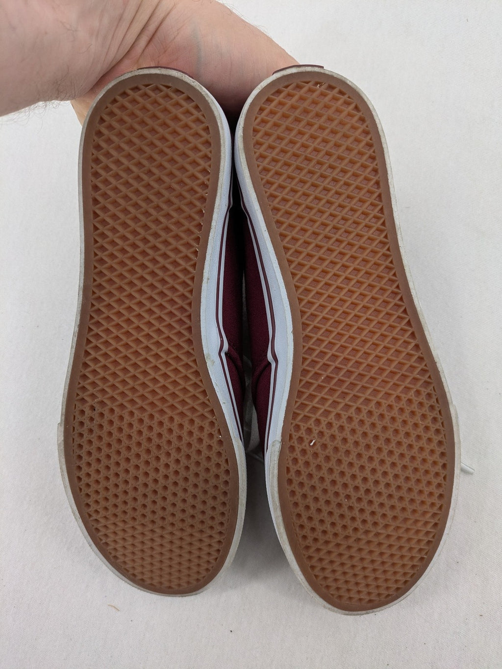 Vans low-top sneakers burgundy canvas with white logo and classic waffle sole.