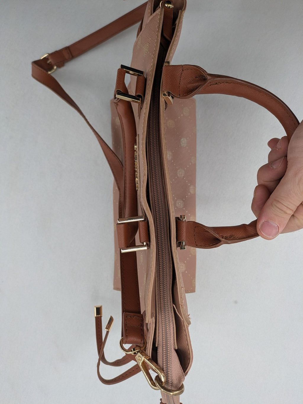 Catwalk gold handbag with pink and brown monogram pattern, adjustable shoulder strap.