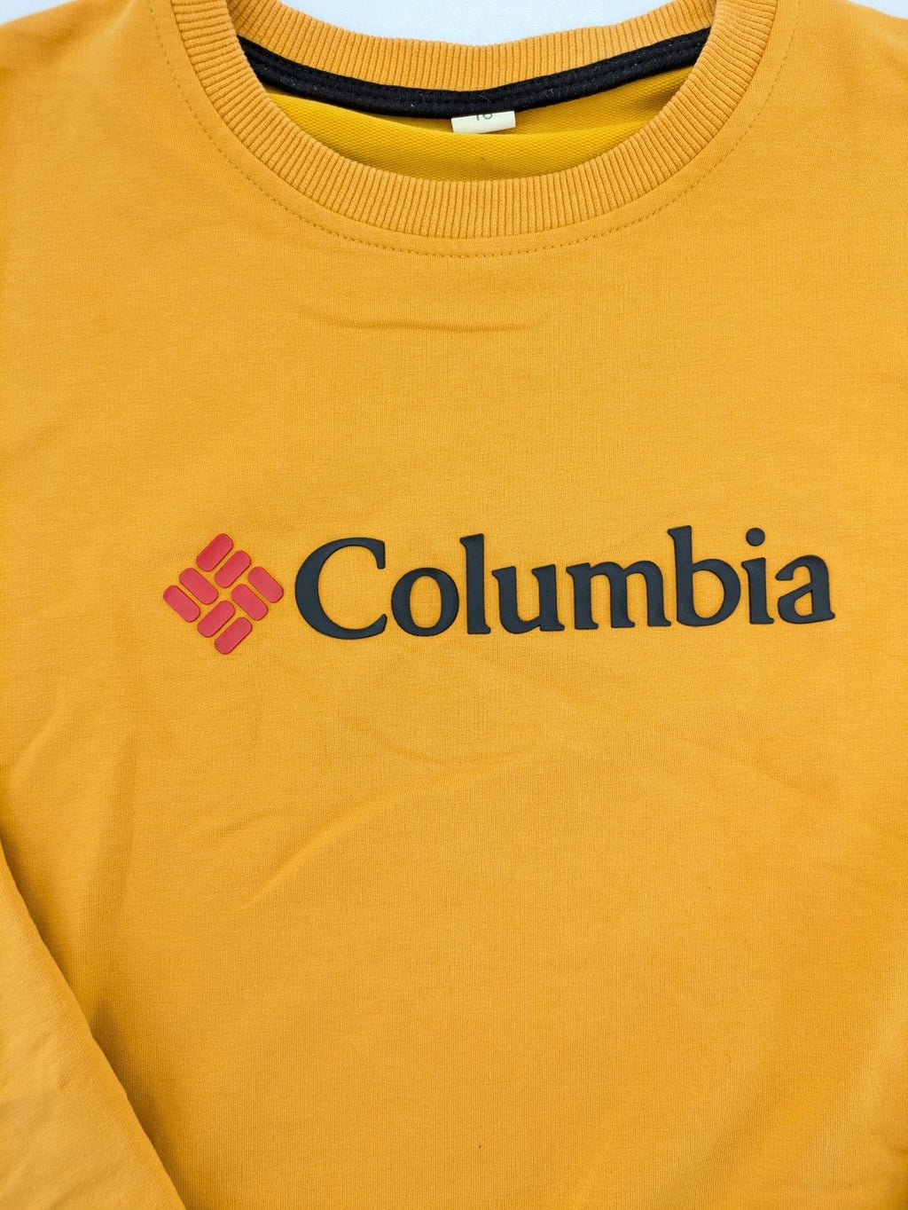 Columbia yellow turtle neck jumper with iconic logo, ribbed cuffs, and soft cotton material.