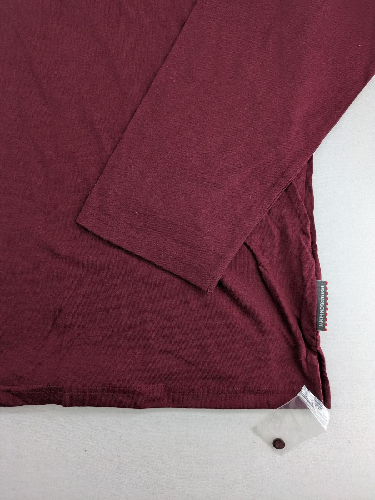 Jan Vanderstorm burgundy Henley shirt with button placket and "087 JV DEPT" graphic print.