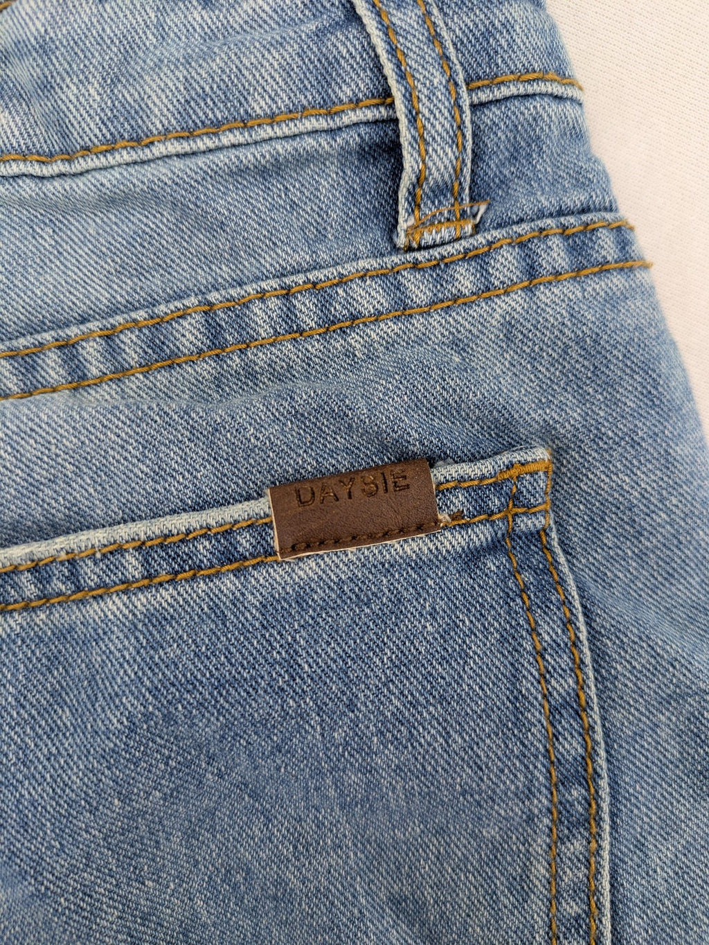 Daysie blue boyfriend jeans shorts with distressed rips and classic 5-pocket design.