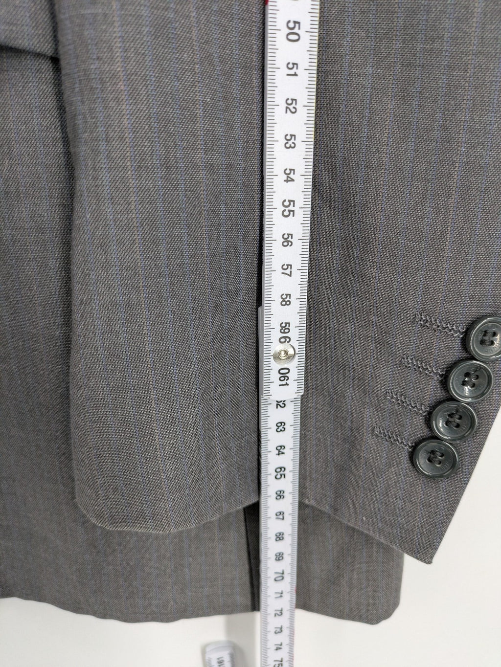 Alextrading grey jacket with subtle light blue pinstripe pattern and notch lapels.