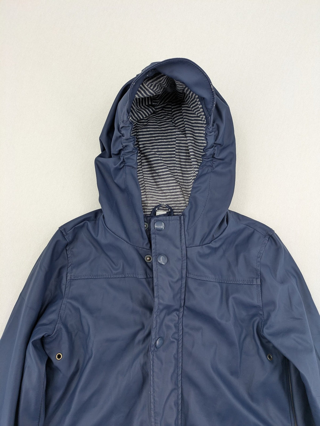 Pocopiano navy raincoat with striped lining and waterproof exterior, classic fisherman style.