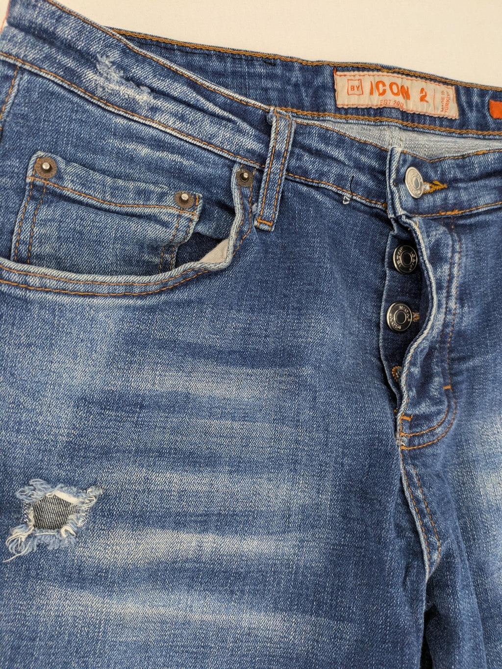 ICON 2 blue slim fit jeans distressed stretch denim with button fly and faded details.