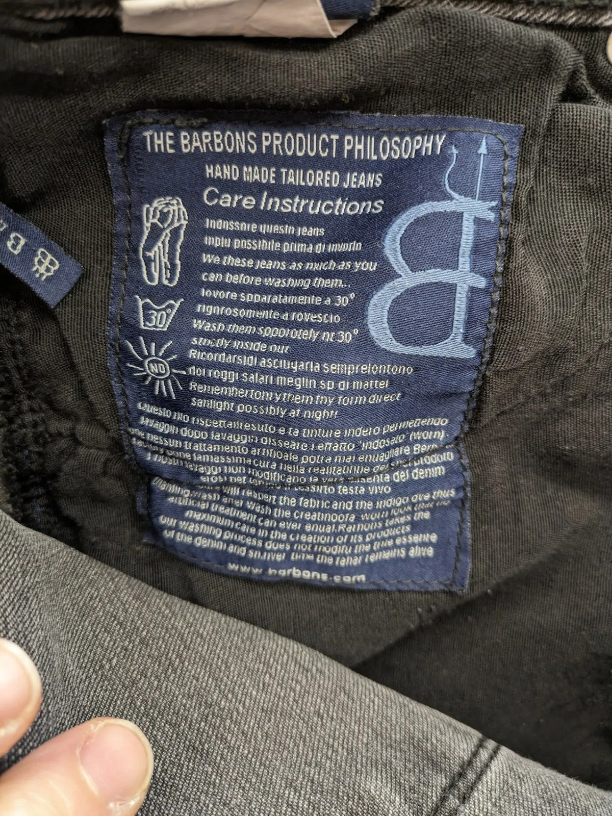 Denim grey straight jeans 5-pocket design with subtle brand details and zipper closure.
