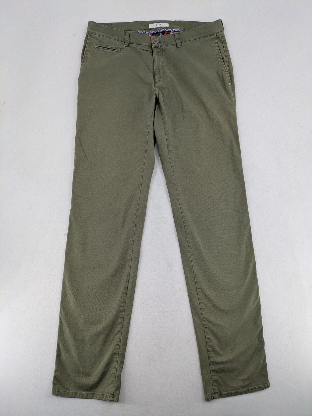 BRAX green chino pants flat-front design with zipper and buttoned back pockets.