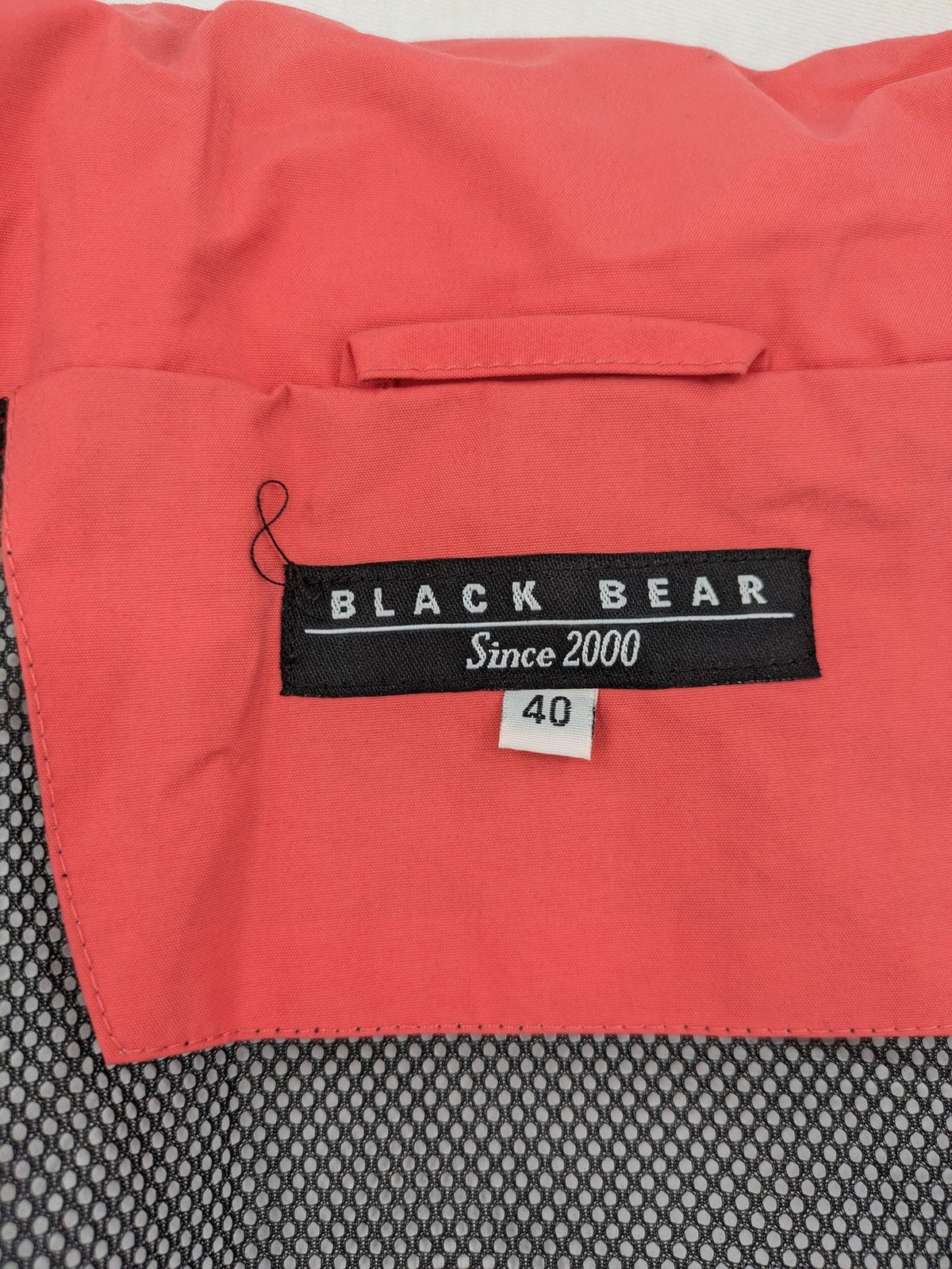 Black Bear black rain jacket with coral pink mesh lining and full zipper.