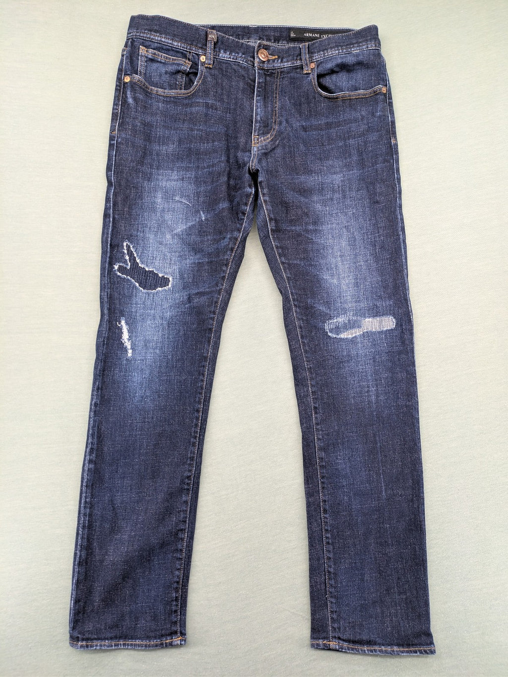 Armani Exchange blue slim fit jeans with distressed details and classic 5-pocket design.