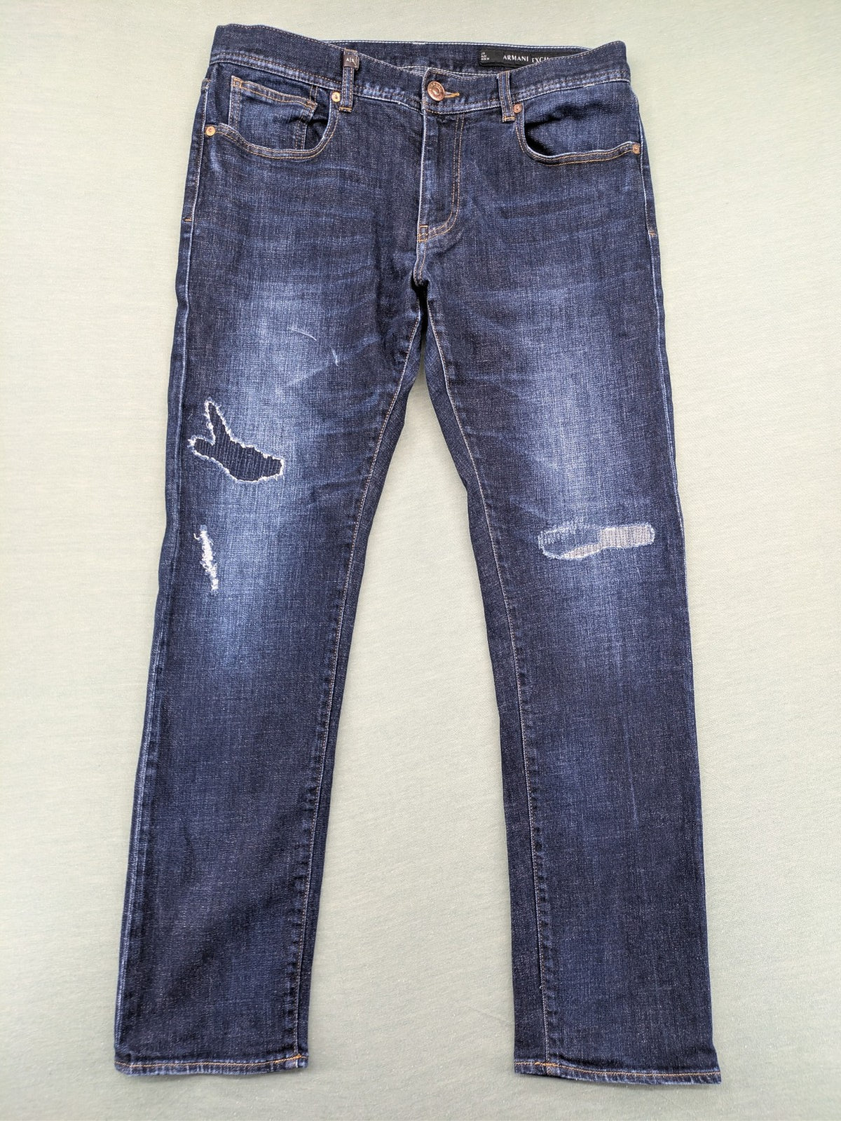 Armani Exchange blue slim fit jeans with distressed details and classic 5-pocket design.
