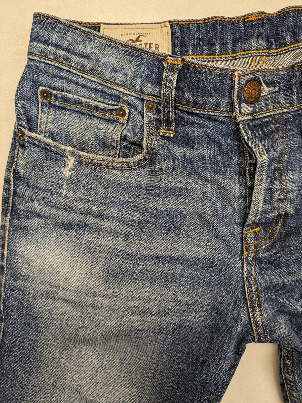 Hollister blue slim fit jeans with distressed detailing and classic button fly.