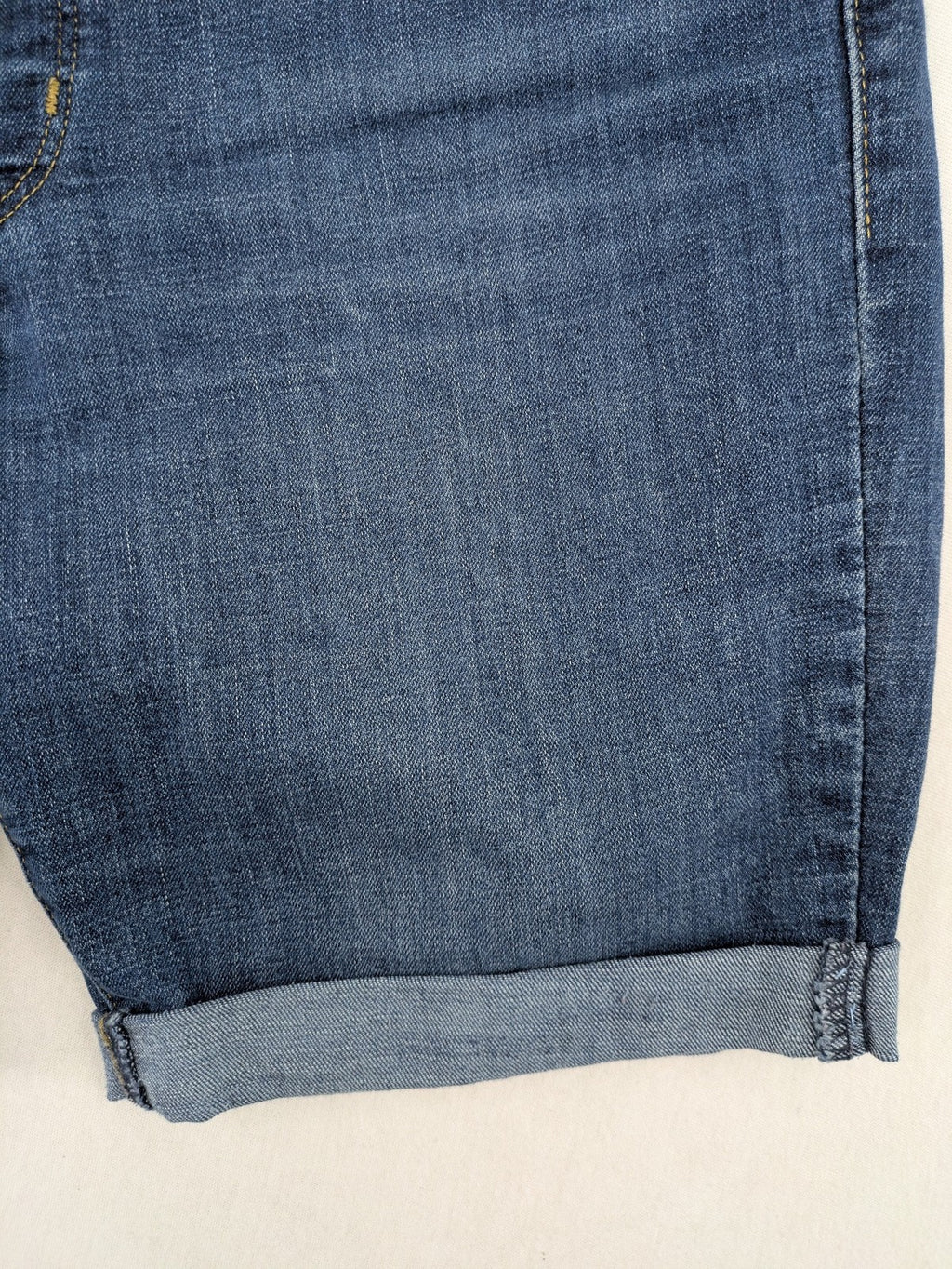 Levi's blue denim Bermuda shorts with rolled cuffs and classic 5-pocket design.