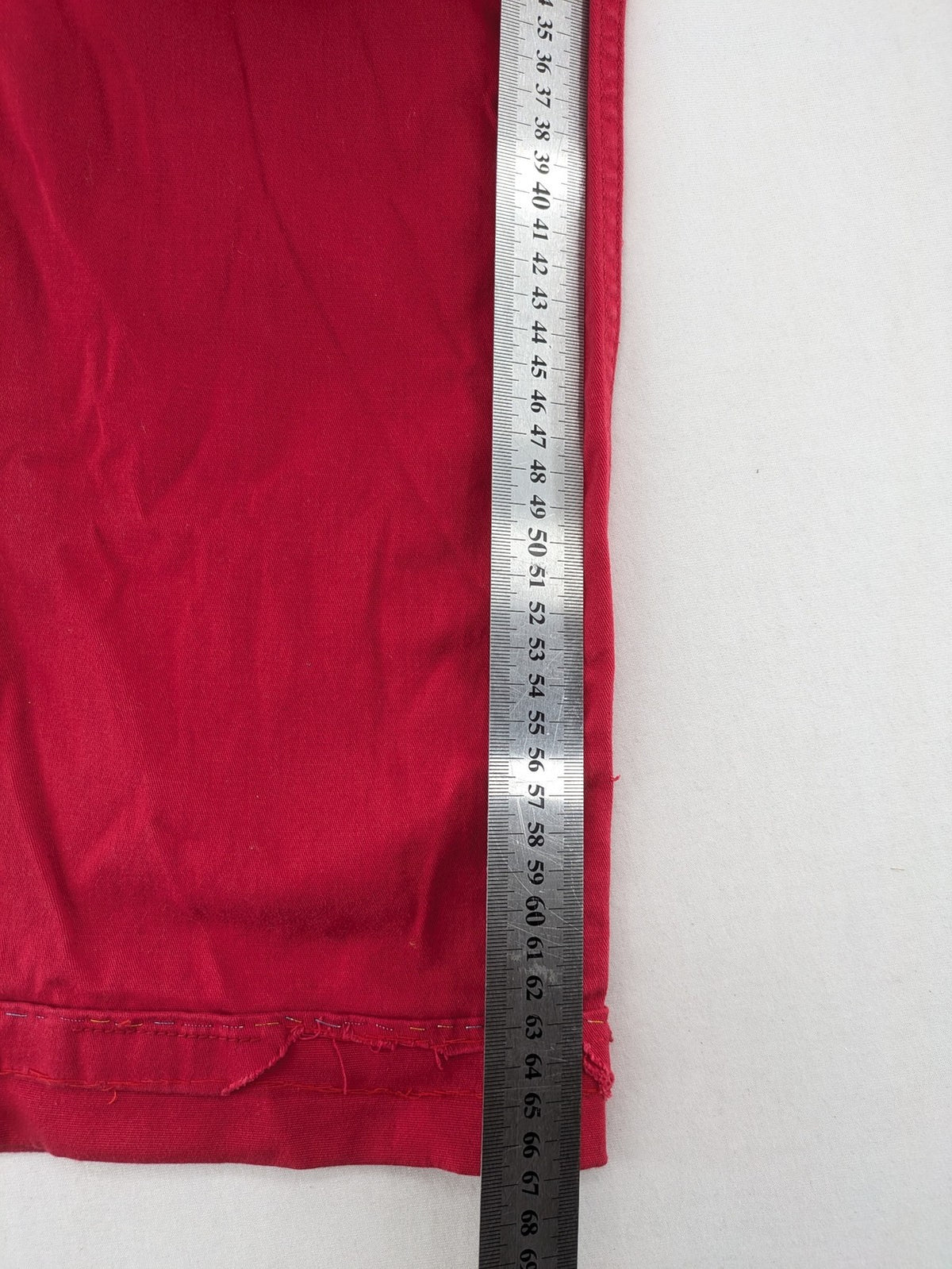 Jet Line red bootcut jeans with embroidered back pockets and pearl embellishments.