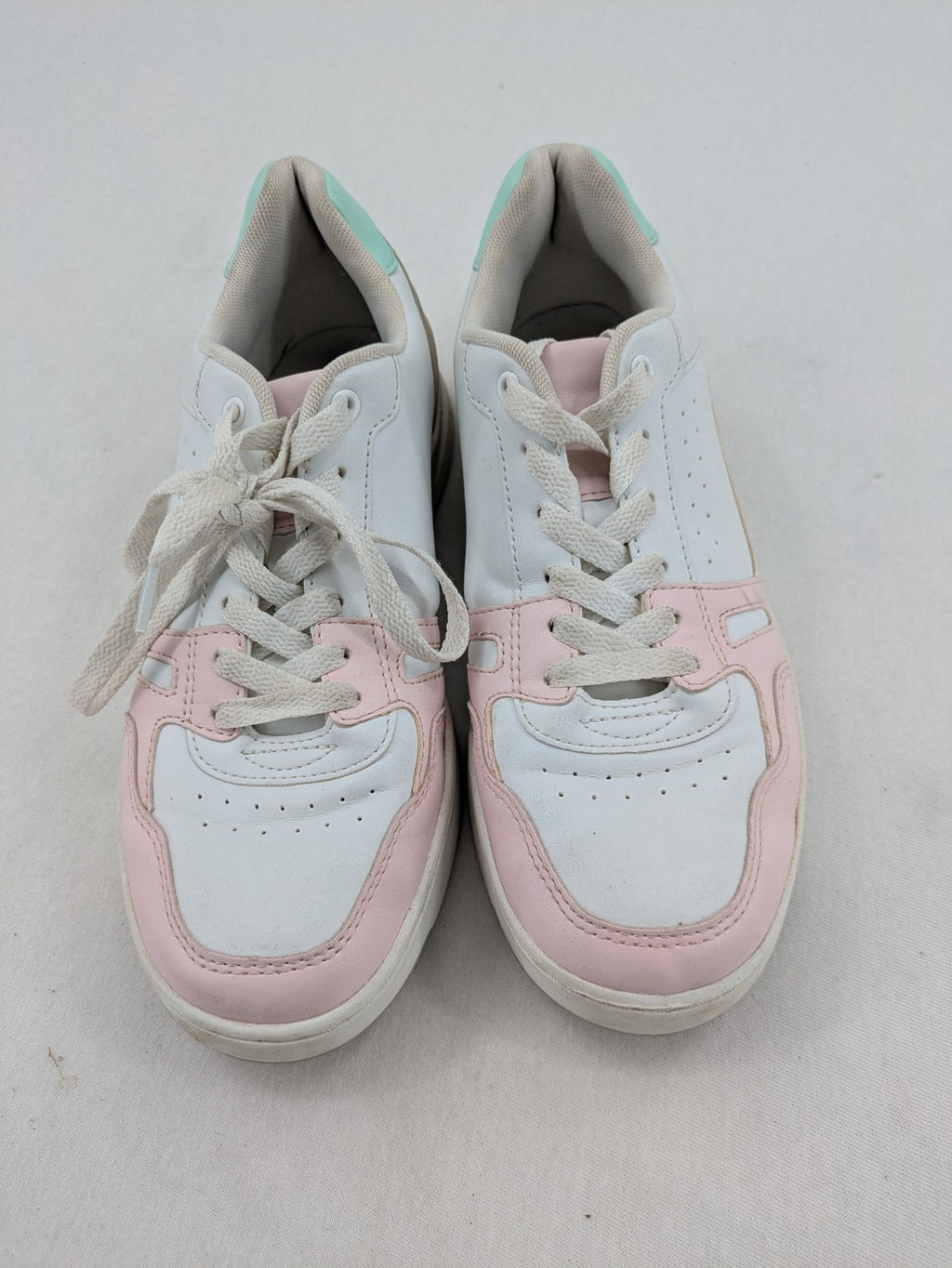 Graceland white sneakers with pink and mint green accents, low-top design, cushioned tongue.