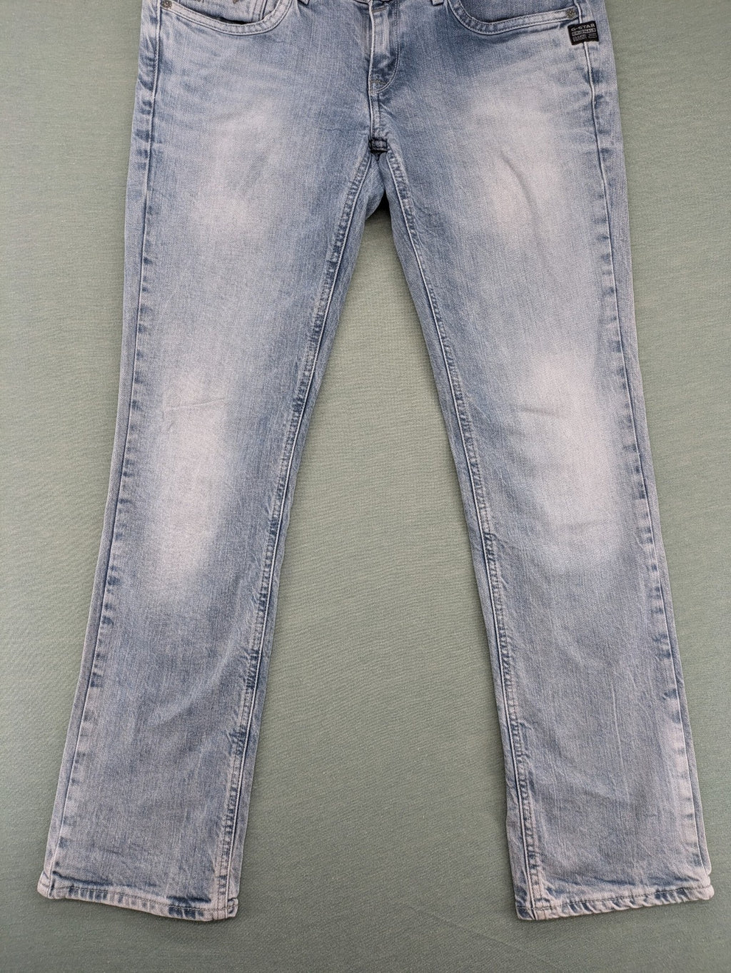 G-Star Raw blue straight leg jeans with classic 5-pocket design and light wash denim.