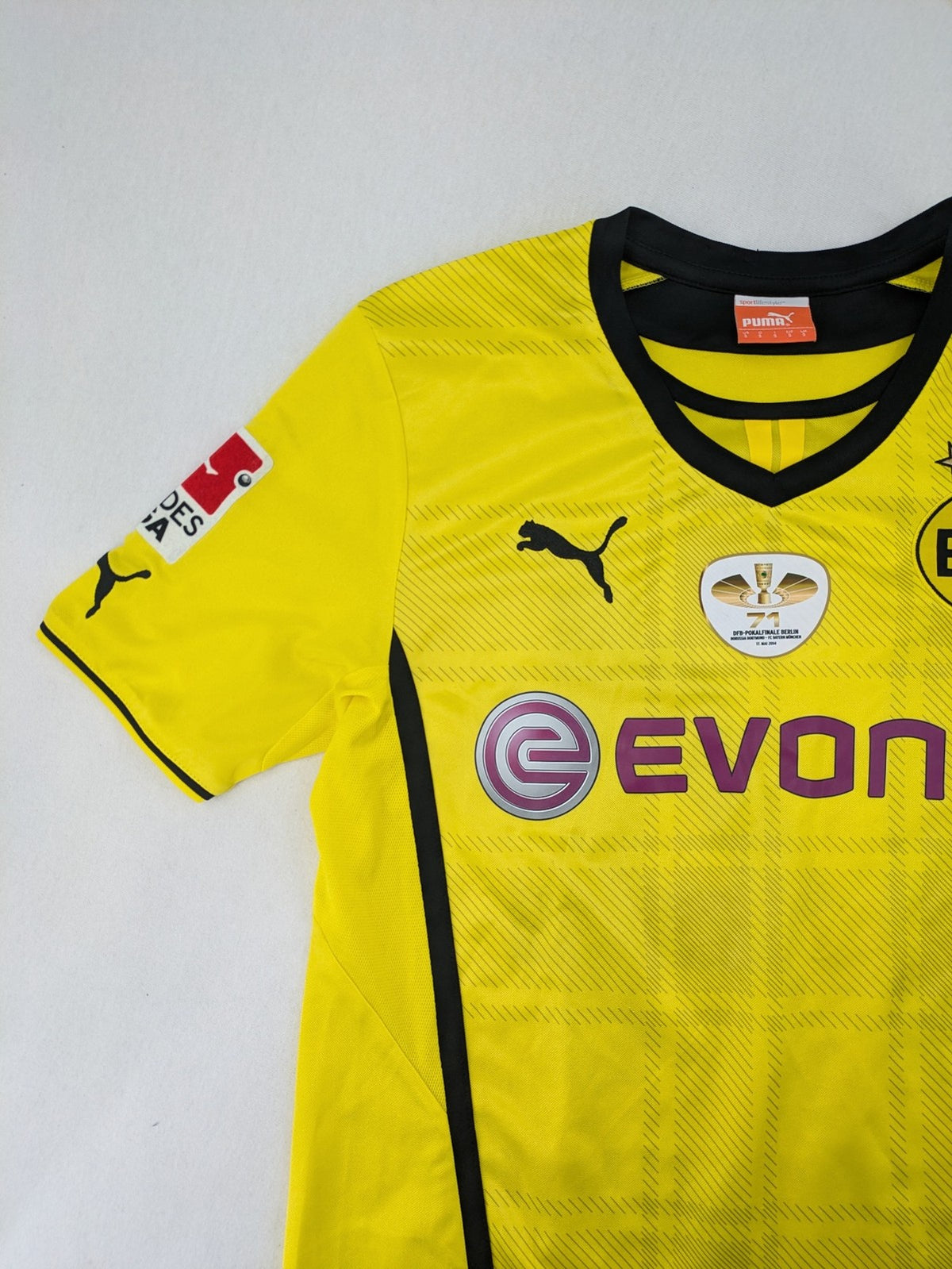 Borussia Dortmund black and yellow soccer uniform with DFB Pokal 2014 patch and Puma logo.