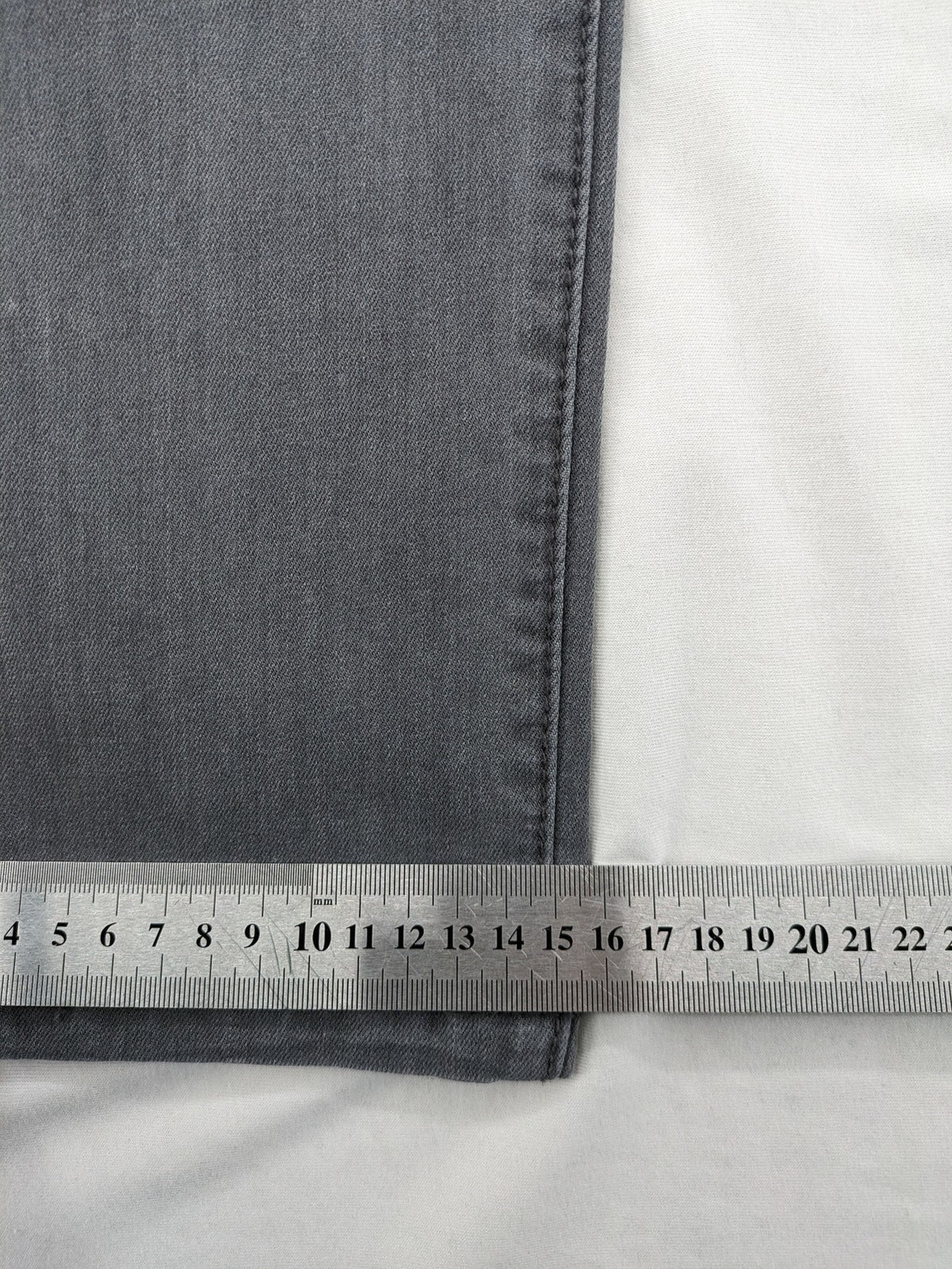 Born Rich grey slim fit jeans with button fly and washed denim texture.